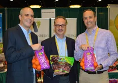 Fred Vandenberg shows Terra Sur grapes from Peru. He is flanked by Michael Schiro and Brian Schiro who both show Sunray mandarins.